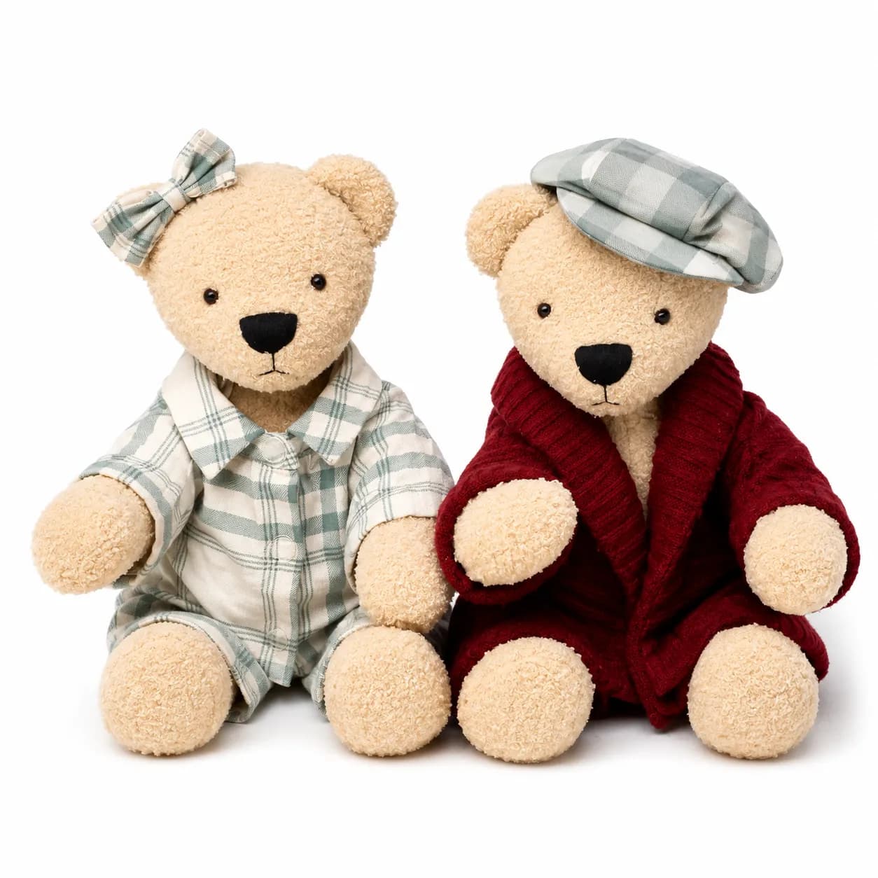 Two cream memory bears, one in green plaid with a bow, the other in a burgundy cardigan and matching cap