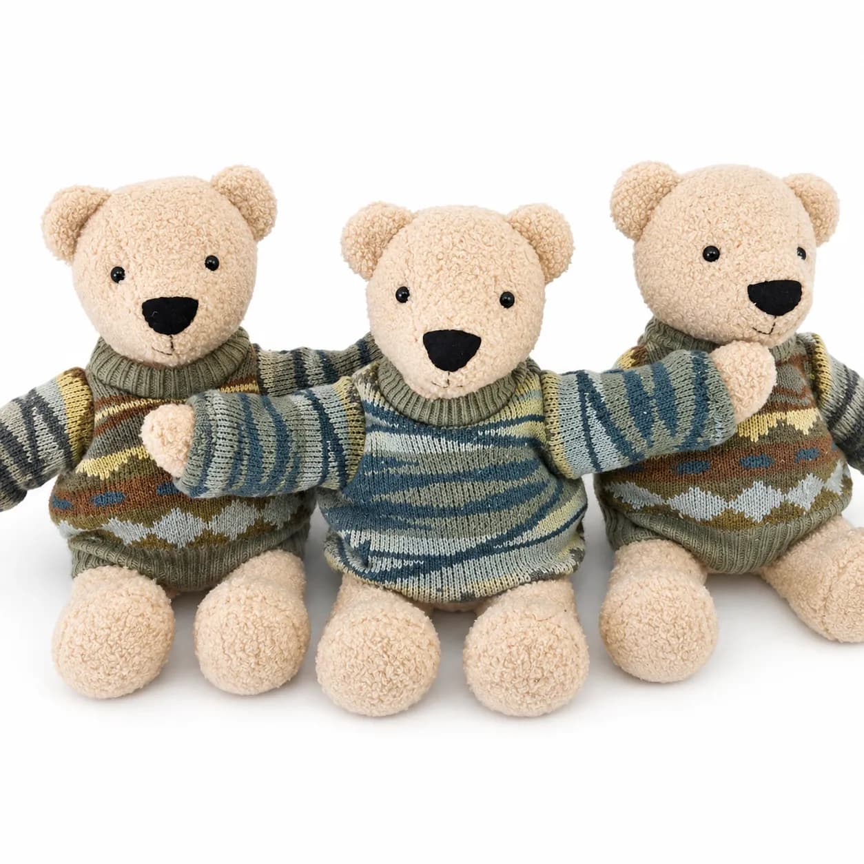 Three cream memory bears in matching knitted jumpers, sitting together